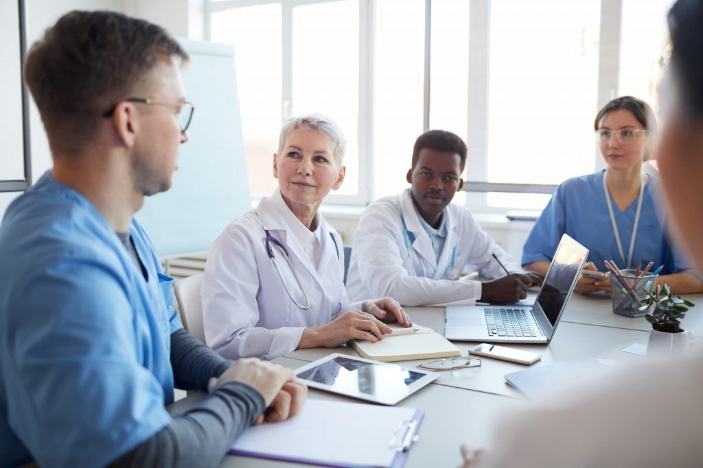 doctors and other people of NMC discussing health ethics